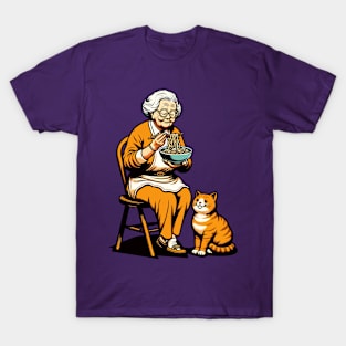 Grandma sitting on a chair with a cat, both enjoying noodles T-Shirt